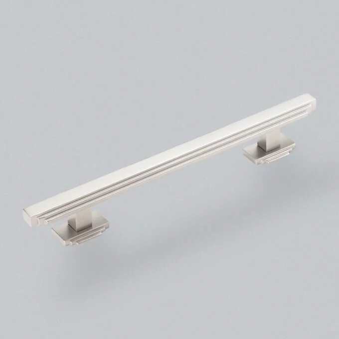 Modern stainless steel cabinet handle on gray background