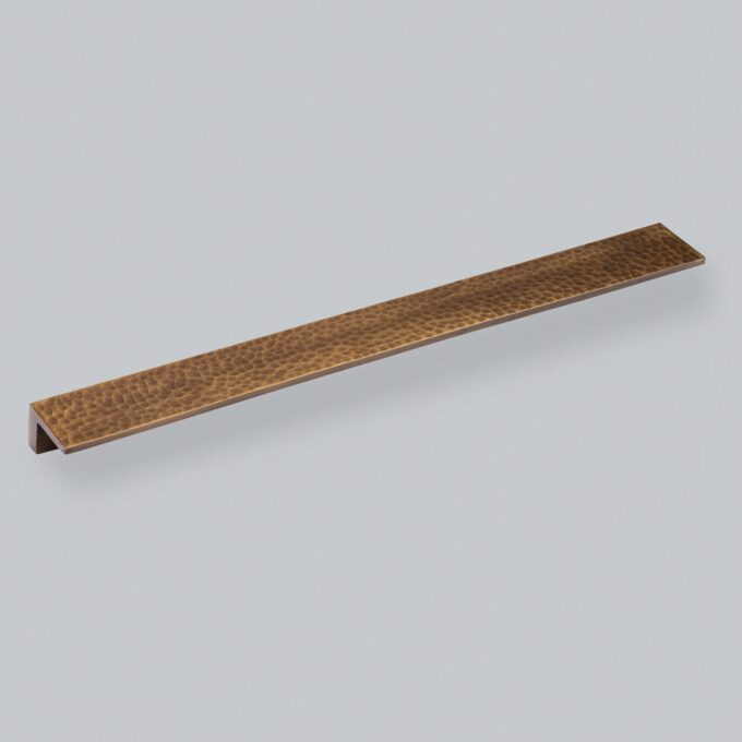 Bronzed, textured metal angle trim on white background.