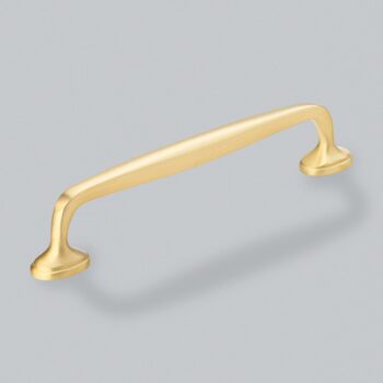 Gold cabinet handle on grey background.