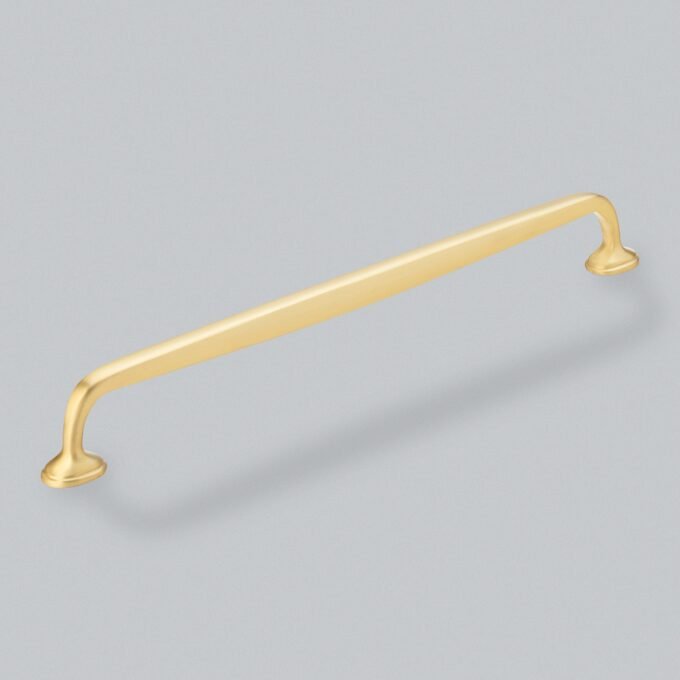 Gold cabinet handle on grey background.