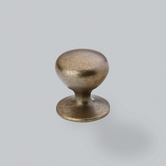 Vintage bronze door knob on grey background.