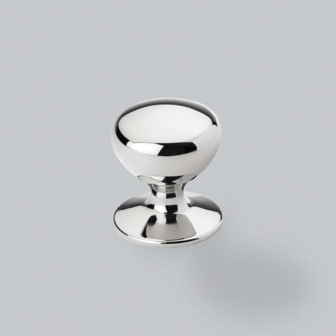 Polished chrome cabinet knob on grey background