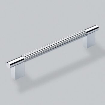 Chrome cabinet handle on white surface.