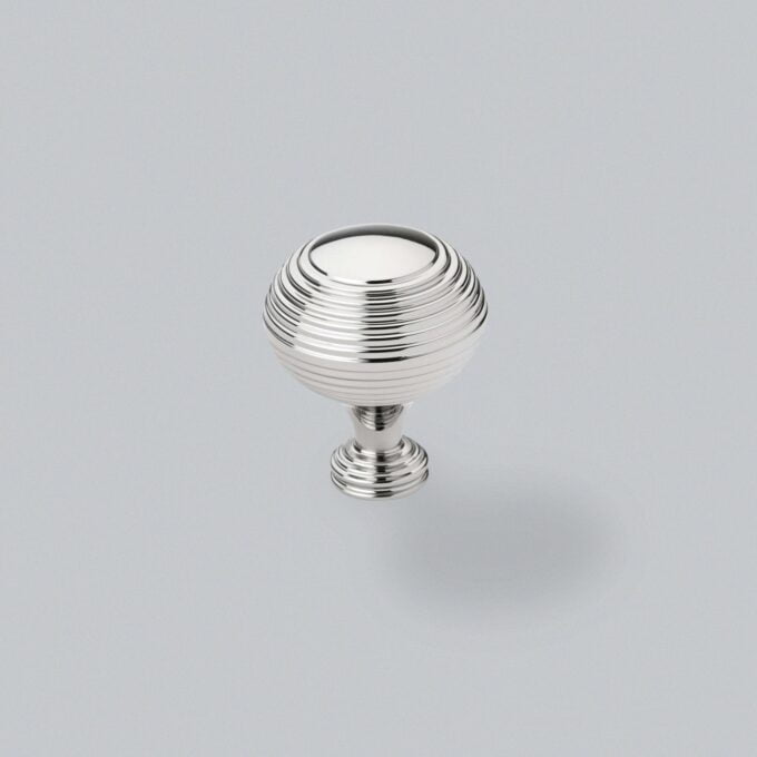 Silver ribbed cabinet knob on grey background