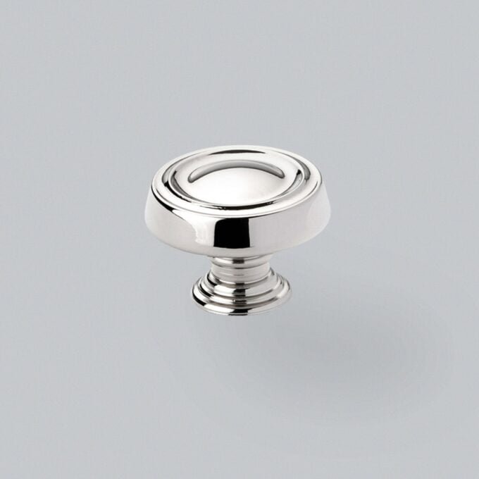 Chrome drawer knob on grey background