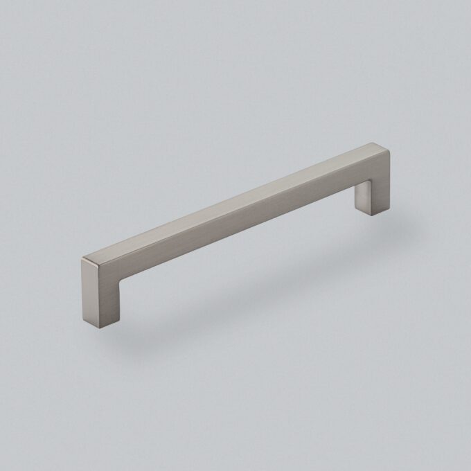 Stainless steel cabinet handle on white background.