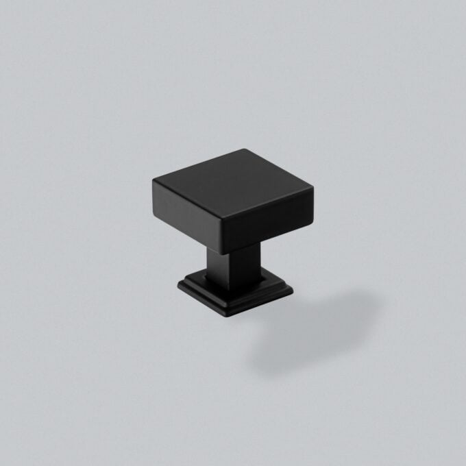 Minimalist black cube on stand against grey background