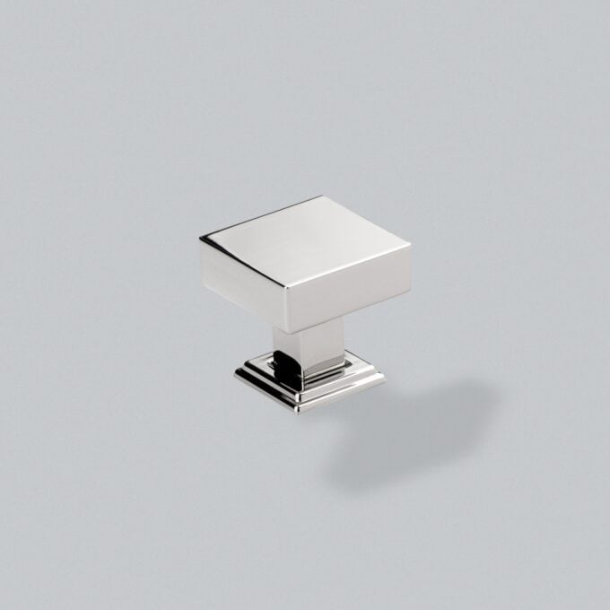 Modern chrome square cabinet knob on grey background