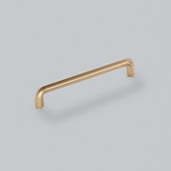 Gold cabinet handle on a grey background