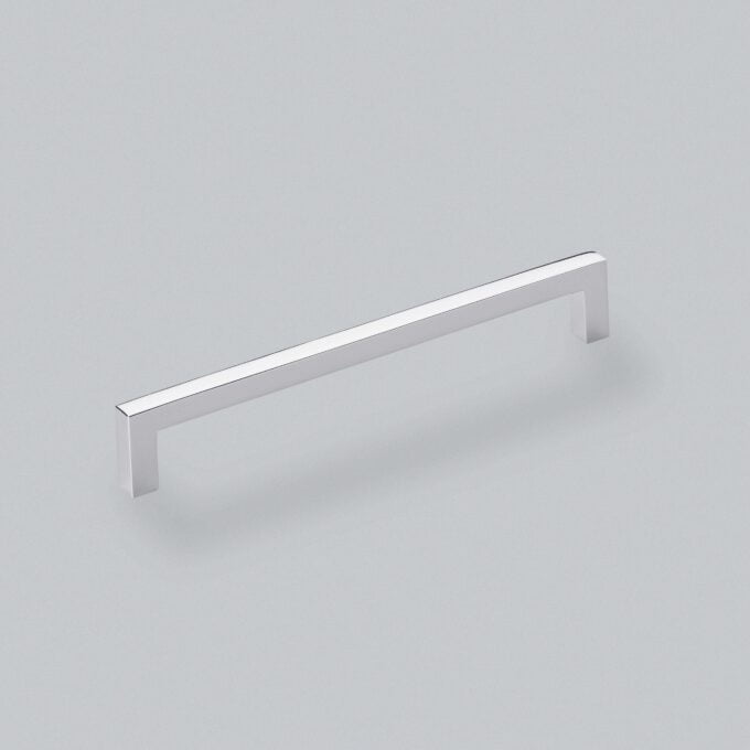 Minimalist silver cabinet handle on grey background