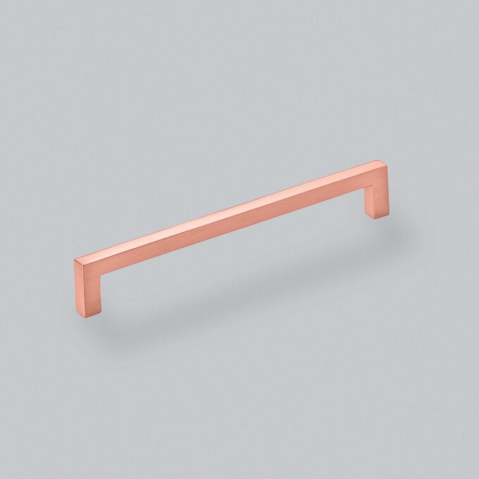 Copper handle floating on pale blue background.