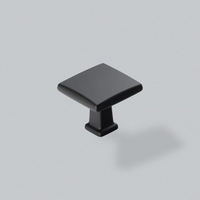 Black cabinet knob on grey background