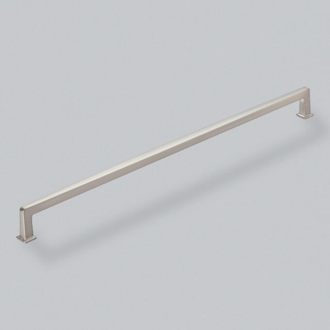 Stainless steel cabinet handle on grey background.