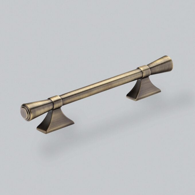 Antique bronze cabinet handle on grey background.