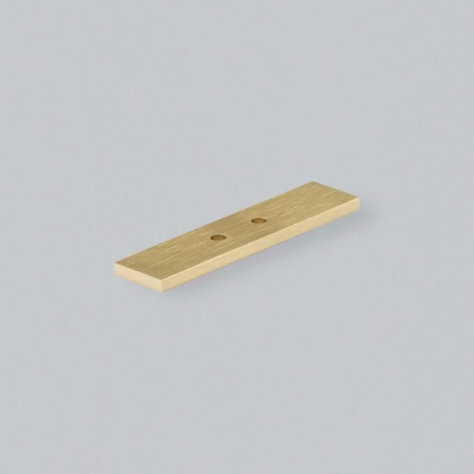 Brass door strike plate on blue background