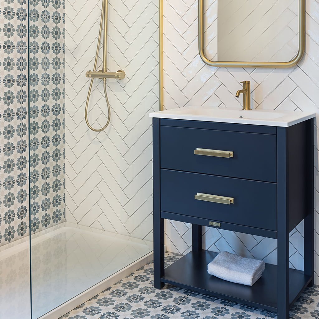 Barrington handels in brushed brass, on dark blue bathroom freestanding cabinet