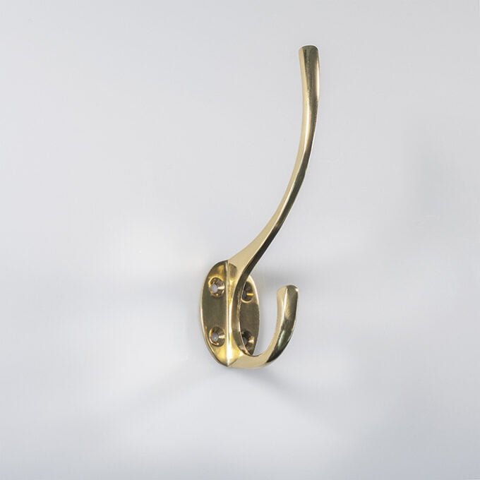 Brass wall hook on white background.