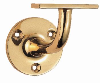 Polished brass sash window lock detail.