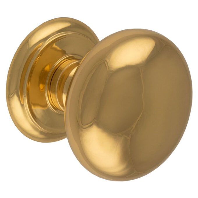 Gold doorknob on white background.