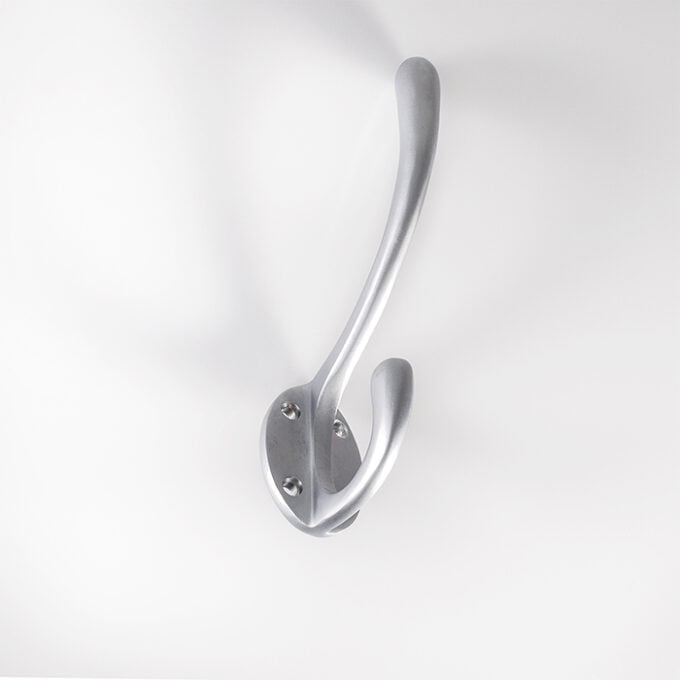 Silver wall-mounted coat hook on white background.