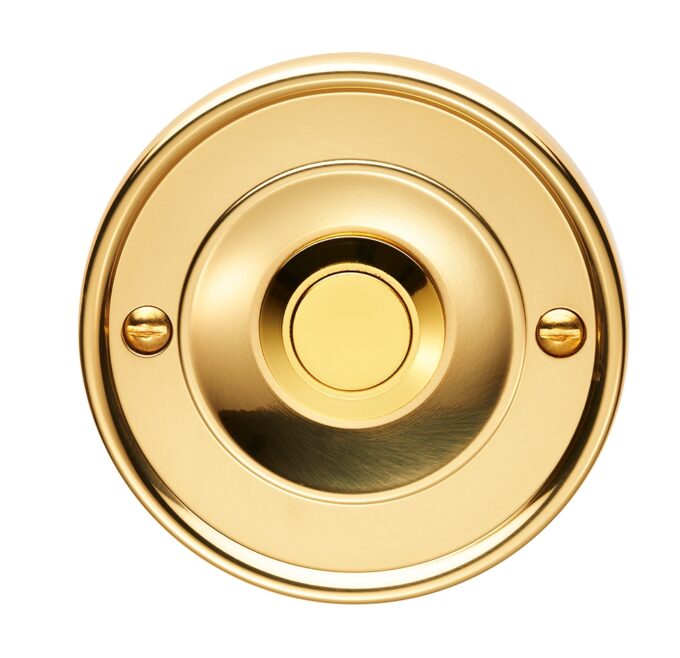 Gold circular doorbell button, isolated on white.