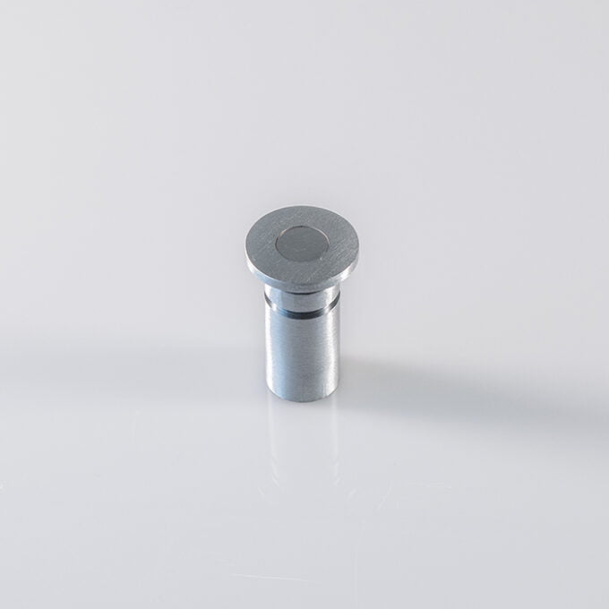 Metal cylindrical component on white background