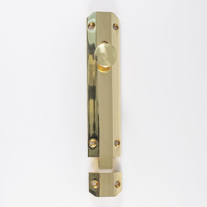 Brass door flush bolt on white background