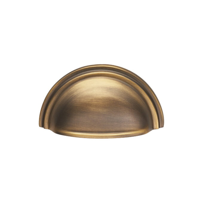 Antique brass cabinet handle, half-moon design.