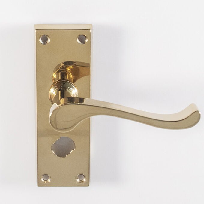 Gold door handle with lock on white background.