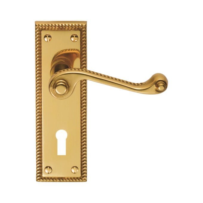 Gold door handle on decorative plate with keyhole