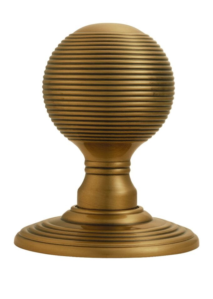 Golden ribbed sphere on elegant pedestal base.