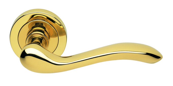 Polished gold door handle on white background.