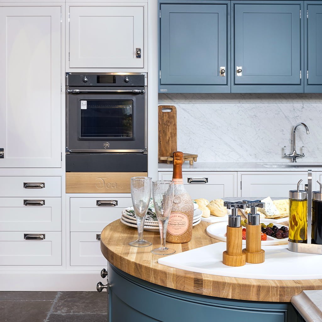 Stylish kitchen with modern appliances and blue cabinets.